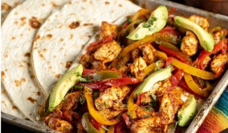 Sheet Pan Chicken Fajitas with sliced avocado and tortillas