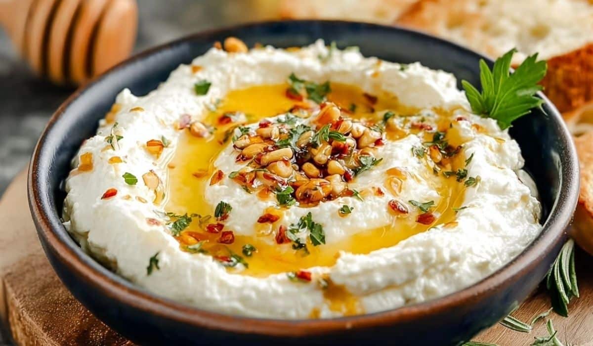 Spicy Ricotta Dip with Hot Honey in a black bowl served with bread
