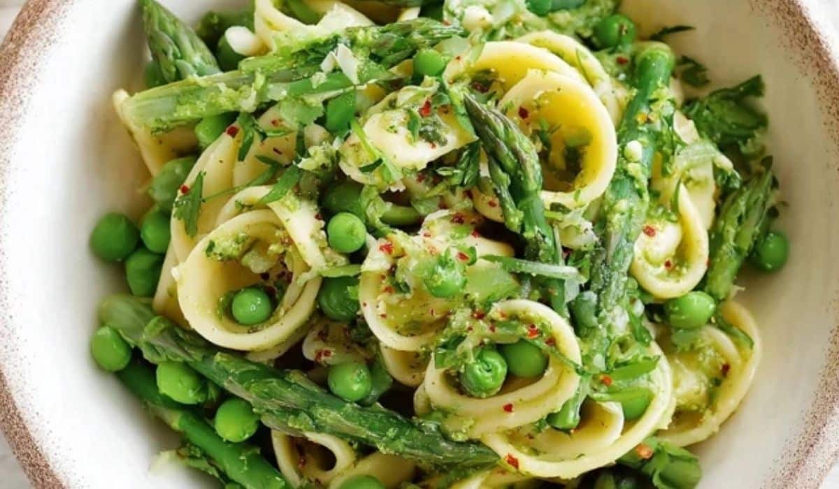 Asparagus Pasta with green peas and orecchiette in a white bowl