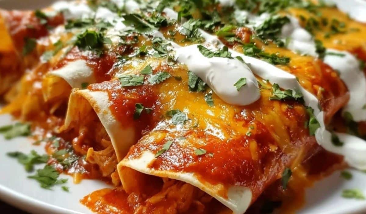 Chicken Enchiladas topped with melted cheese and sour cream