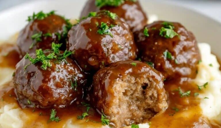 Slow Cooker Salisbury Steak Meatballs served over creamy mashed potatoes
