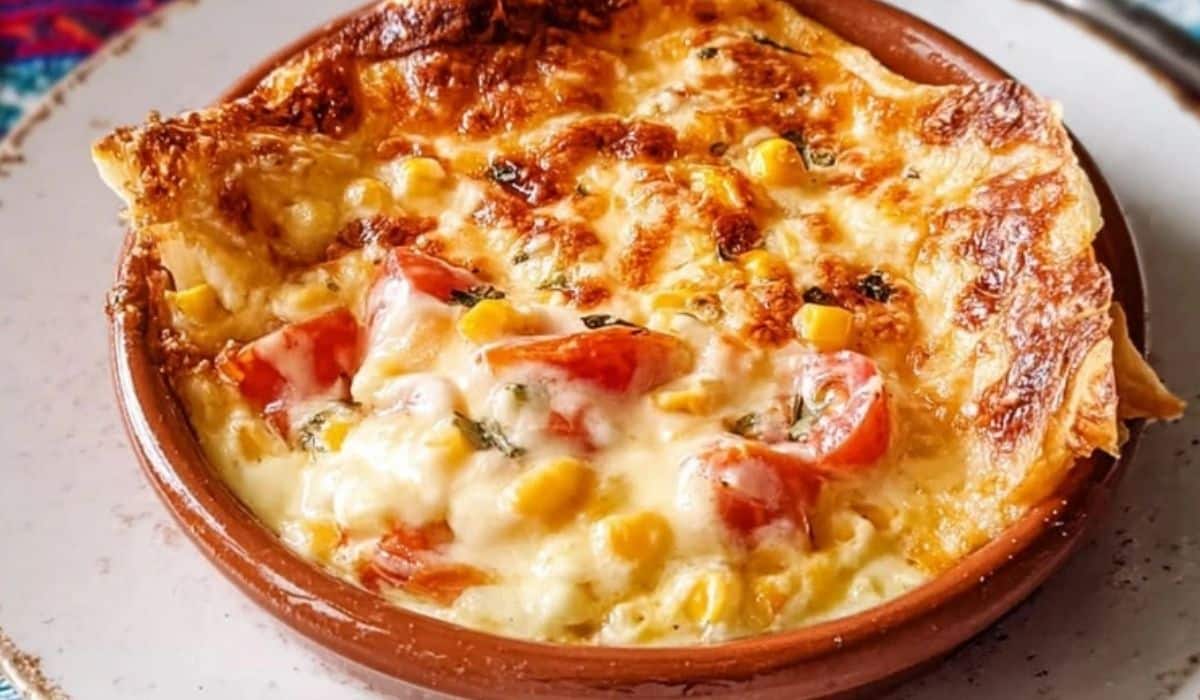 Pastel Azteca Mexican Chicken Casserole served in a rustic clay bowl