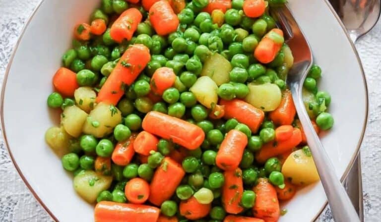 One pan peas and carrots in white bowl with potatoes
