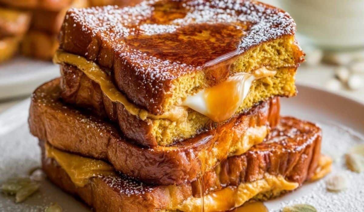 Pumpkin Stuffed French Toast stacked with creamy filling and maple syrup