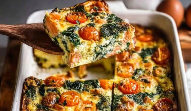 Smoked Salmon Breakfast Casserole with Tomatoes and Spinach served fresh in a white baking dish