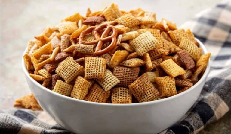 Best Chex Mix Recipe in a white bowl on a rustic napkin