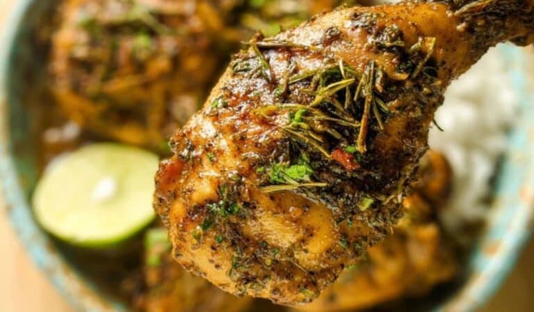 Caribbean Creole Chicken close-up with fresh herbs and lime