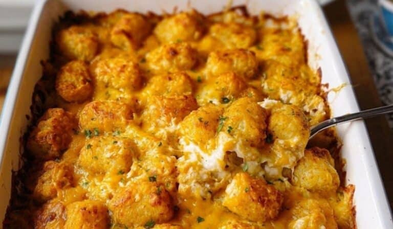 Cracked Out Chicken Tater Tot Casserole in a white baking dish topped with golden crispy tater tots