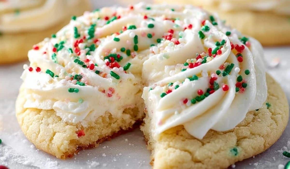 Crumble Christmas Sugar Cookies topped with vanilla frosting and holiday sprinkles