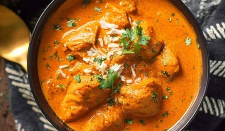 Bowl of creamy dairy free butter chicken garnished with cilantro