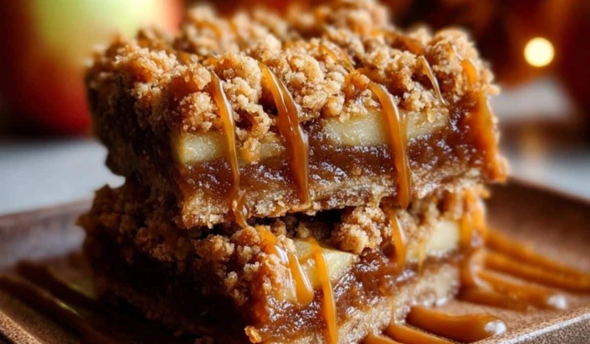Salted Caramel Apple Crumble Bars stacked with golden crumble topping and rich caramel drizzle