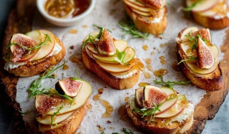 Brie, Apple, and Fig Crostini Appetizer on a rustic board