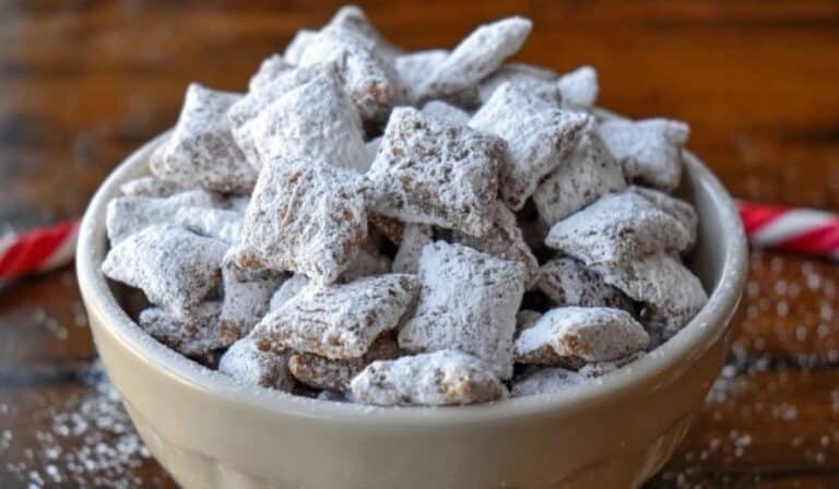 Easy Puppy Chow Recipe in a white bowl on a rustic table