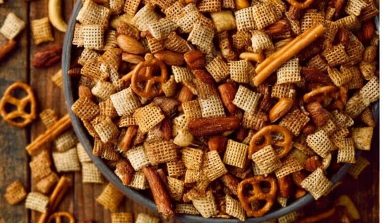 Homemade Chex Mix (Oven or Slow Cooker) in a rustic bowl on wood table