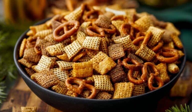 The Best Extra Bold Savory Chex Mix in a black bowl with pretzels and seasoned cereal