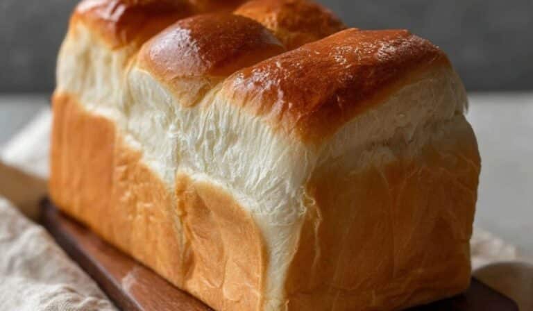 Simple homemade milk bread loaf showing its golden crust and soft, airy crumb