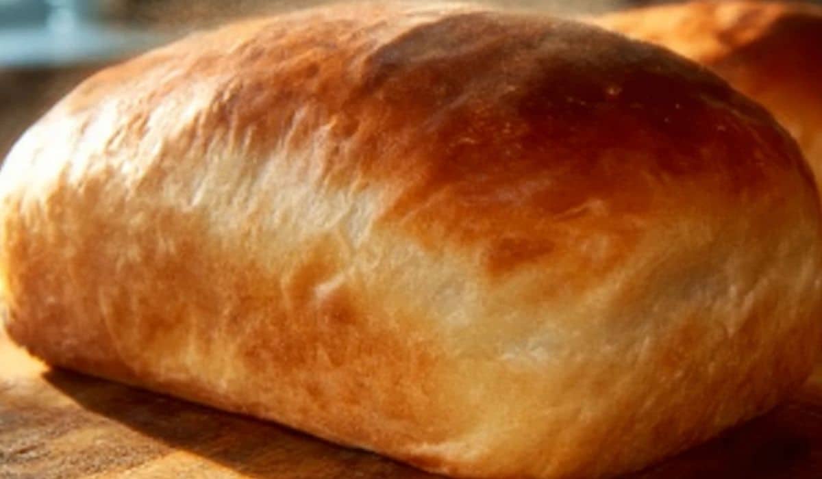 Soft Amish White Bread fresh from oven on rustic table