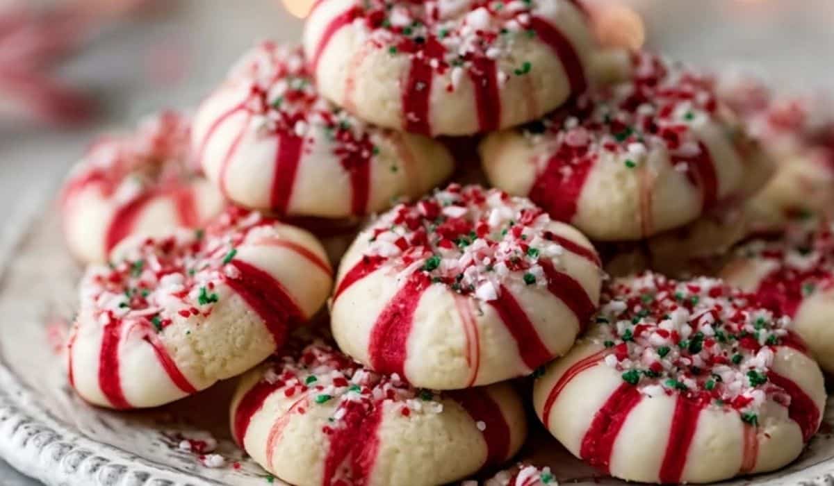 Candy Cane Kiss Cookies stacked on a festive plate