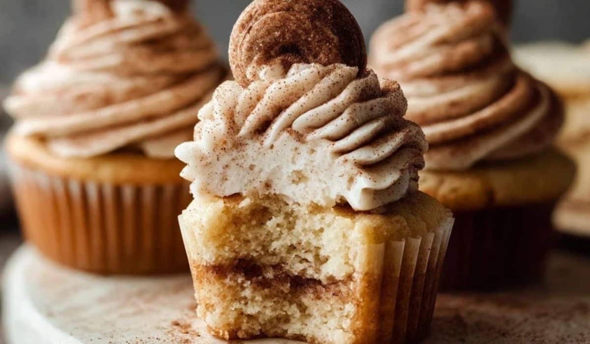 Cinnamon-Swirl Snickerdoodle Cupcakes with frosting on wooden table