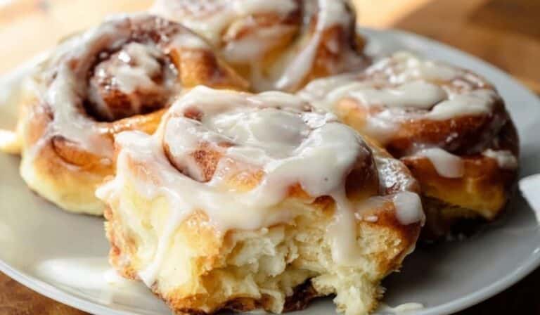Easy Cinnamon Rolls From Scratch on white plate with icing drizzle