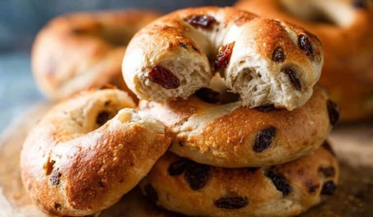 Homemade Cinnamon Raisin Bagels stacked on wooden board