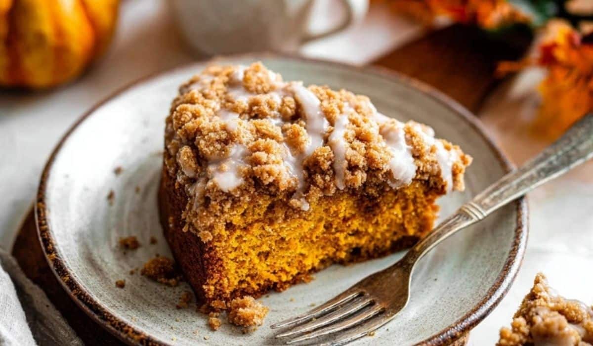 Pumpkin Coffee Cake with Crumb Topping served on rustic plate with coffee