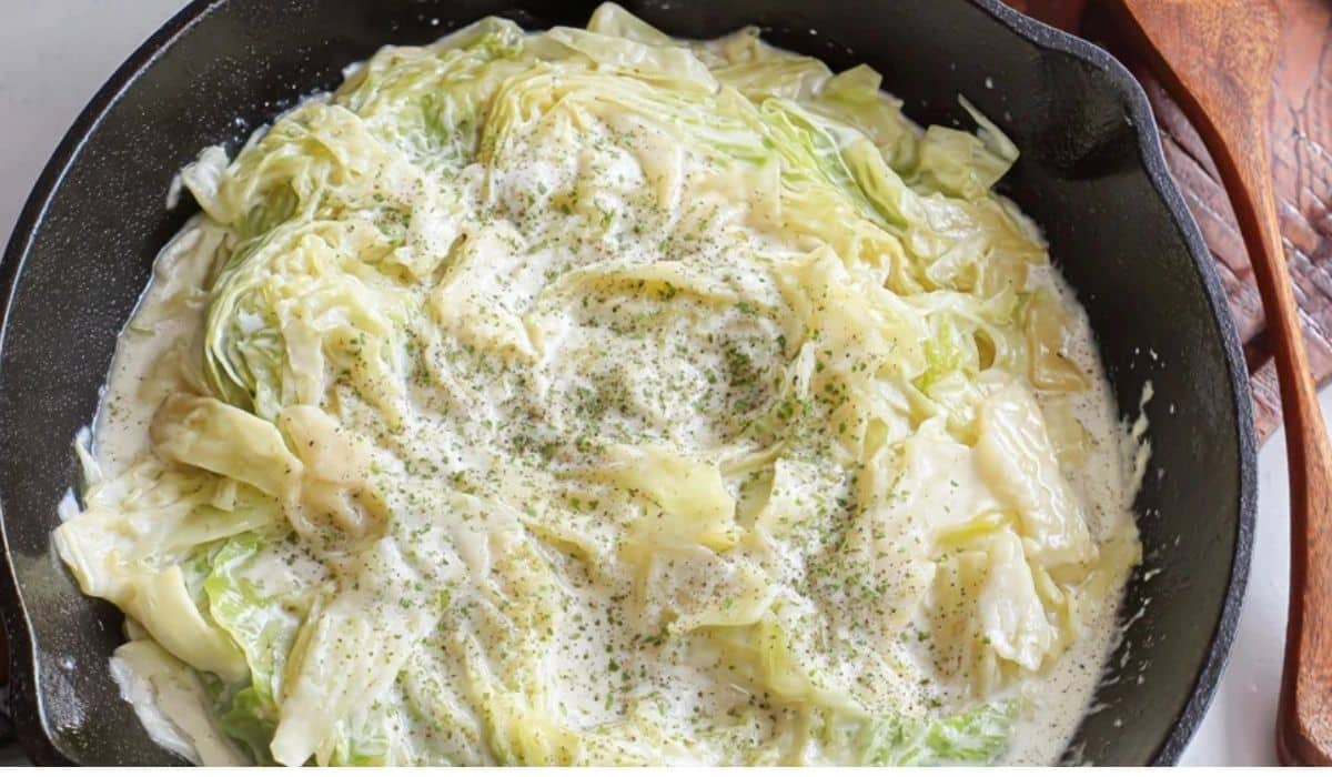 Cabbage ribbons with cream sauce in a skillet with Parmesan and herbs