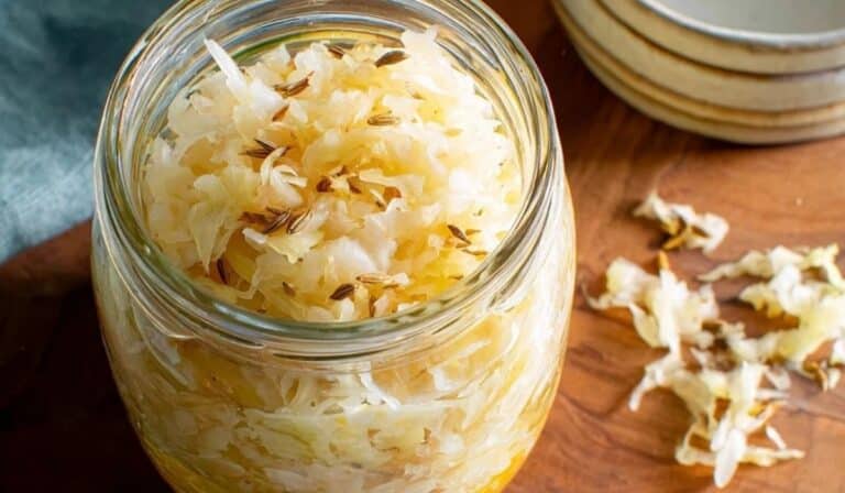 Homemade sauerkraut 7-days in a glass jar with crisp tangy cabbage