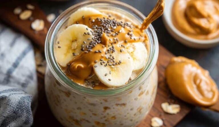 Overnight protein oats with banana in a jar topped with peanut butter drizzle